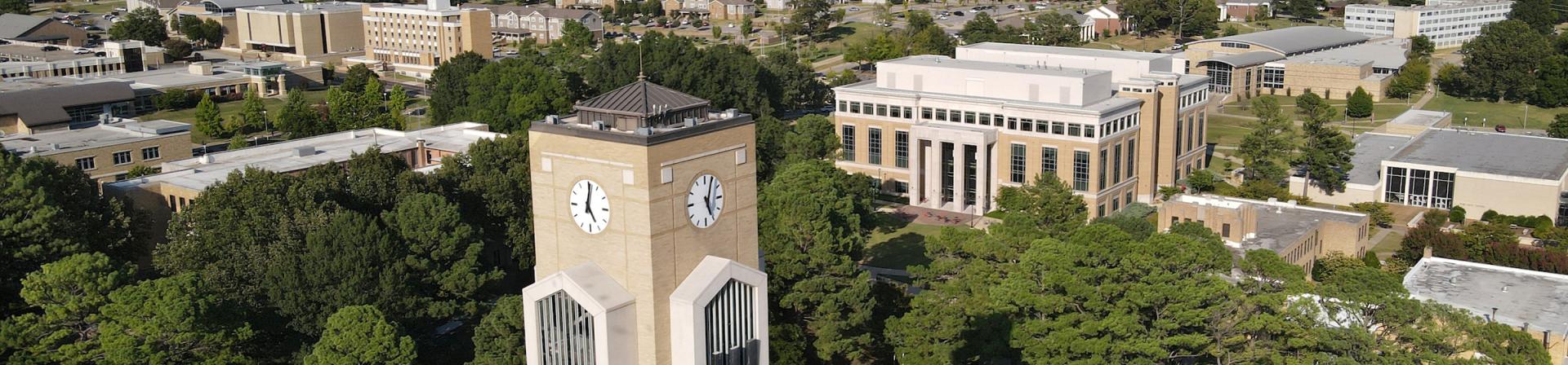 Aerial view of Arkansas State University campus with buildings spread around.