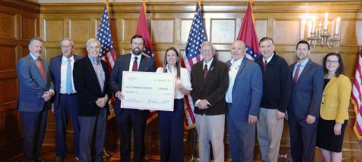 Vice President Steven Lamm of Jonesboro Unlimited holding a large check for $2 million dollars with Governor Sarah Huckabee Sanders and other Arkansas Legislators