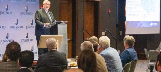 Ted Abernathy at podium speaking to audience at the 2025 Jonesboro Unlimited Annual Meeting